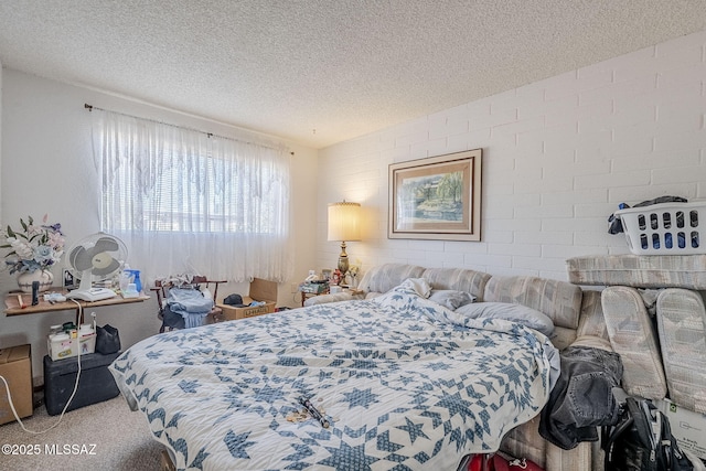 bedroom with carpet floors and a textured ceiling