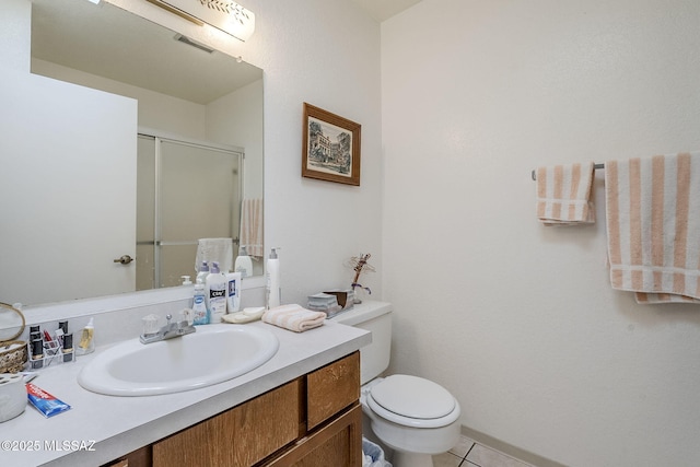 bathroom featuring walk in shower, tile patterned floors, vanity, and toilet