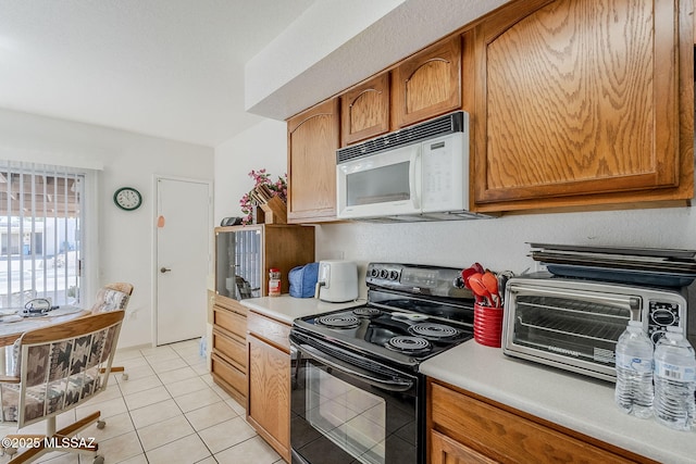 kitchen featuring black range with electric stovetop and light tile patterned flooring