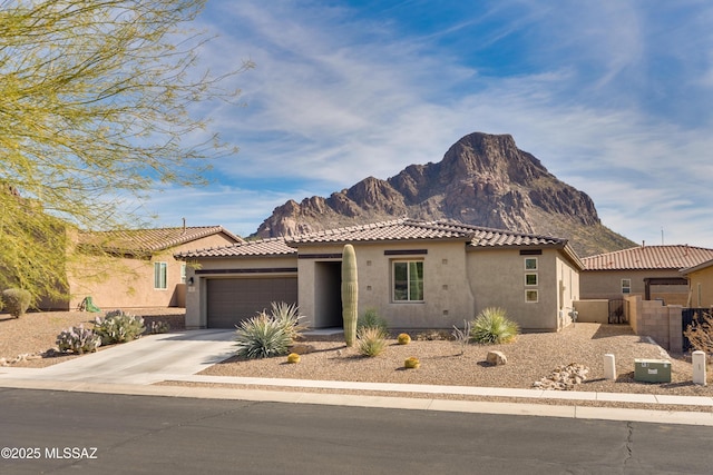 view of front of house featuring a garage and a mountain view