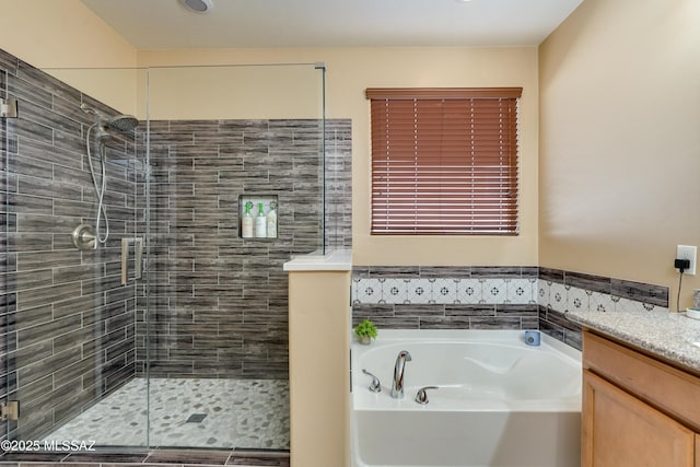 bathroom featuring vanity and separate shower and tub