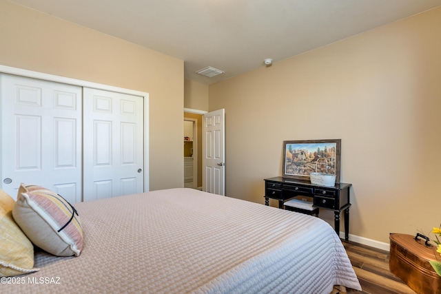 bedroom featuring dark hardwood / wood-style floors and a closet