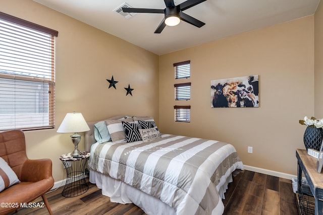 bedroom with dark hardwood / wood-style floors and ceiling fan