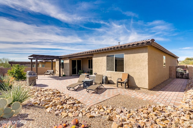 rear view of house featuring a pergola and a patio