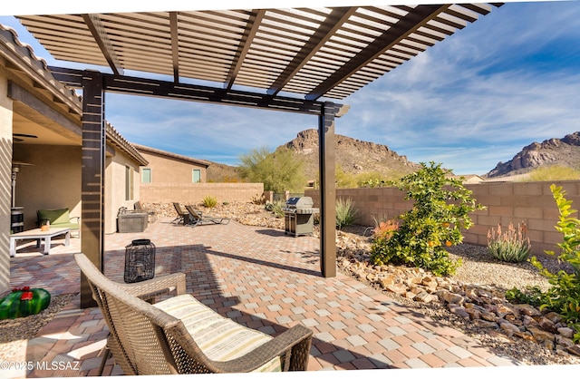 view of patio featuring a grill, a pergola, and a mountain view