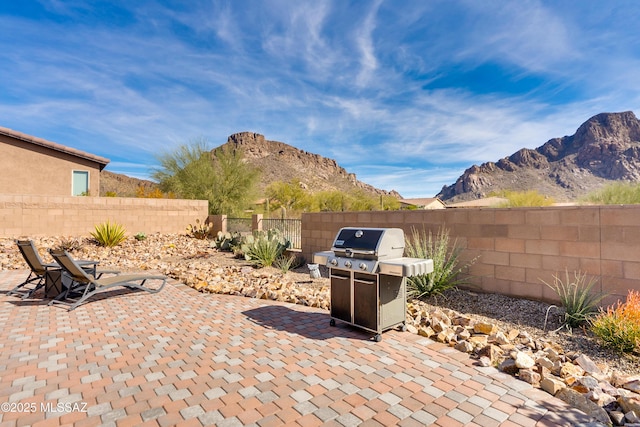 view of patio featuring a mountain view and grilling area