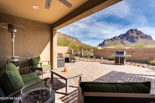 view of patio / terrace with a mountain view, area for grilling, and ceiling fan