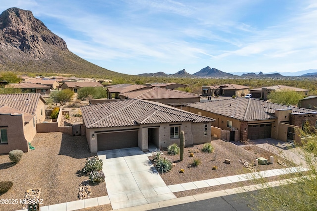 view of front of house featuring a mountain view and a garage