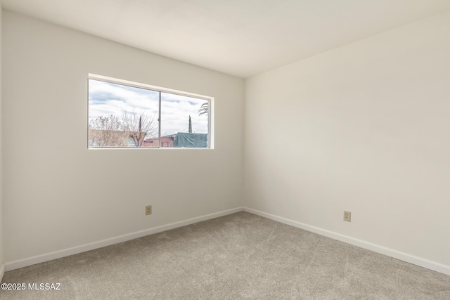 spare room featuring light carpet