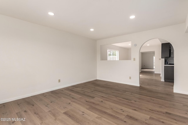 spare room featuring dark wood-type flooring