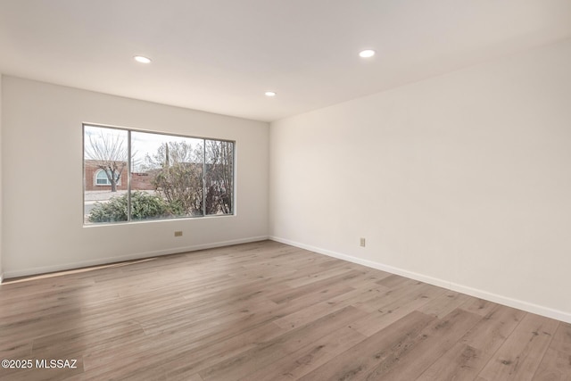 empty room with light hardwood / wood-style flooring