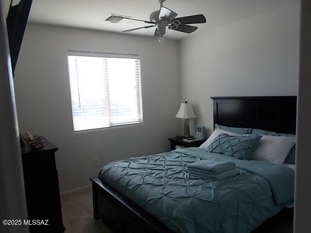 carpeted bedroom with ceiling fan