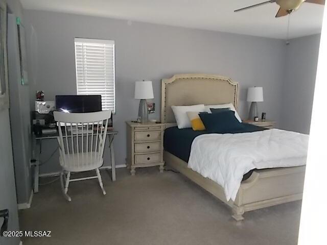 bedroom with ceiling fan and light carpet