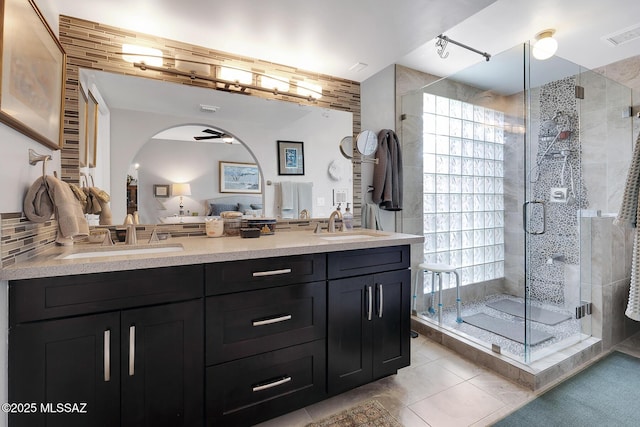 bathroom featuring walk in shower, tile patterned floors, and vanity