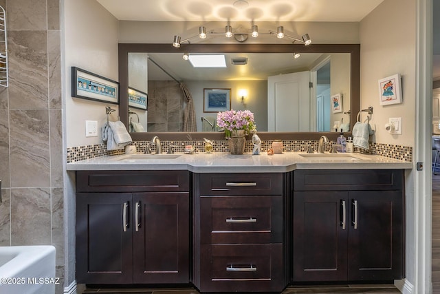 bathroom featuring tasteful backsplash, vanity, and separate shower and tub