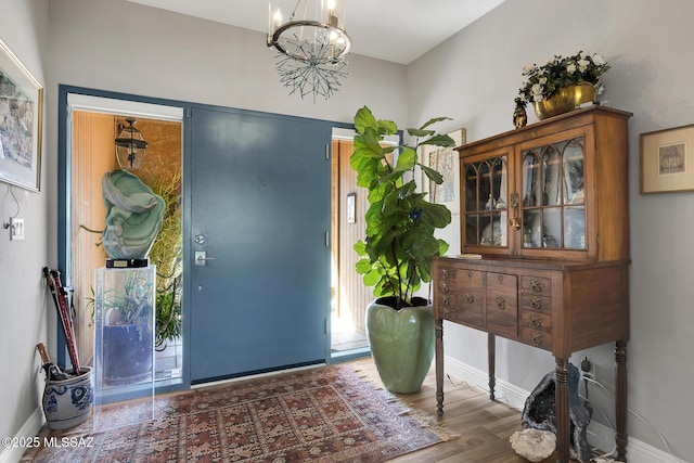 entrance foyer with dark hardwood / wood-style floors and a chandelier