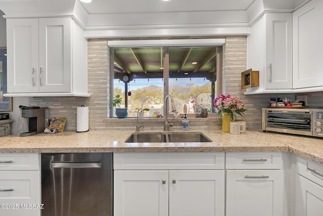 kitchen featuring sink and white cabinets