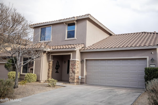 mediterranean / spanish-style home with a garage