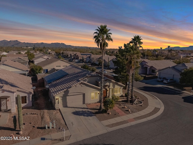 drone / aerial view featuring a residential view and a mountain view