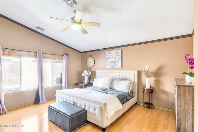 bedroom featuring visible vents, vaulted ceiling, and light wood finished floors