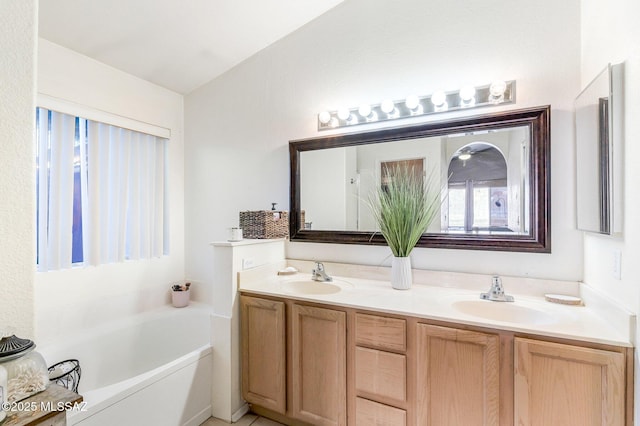 bathroom with lofted ceiling, double vanity, a sink, and a bath