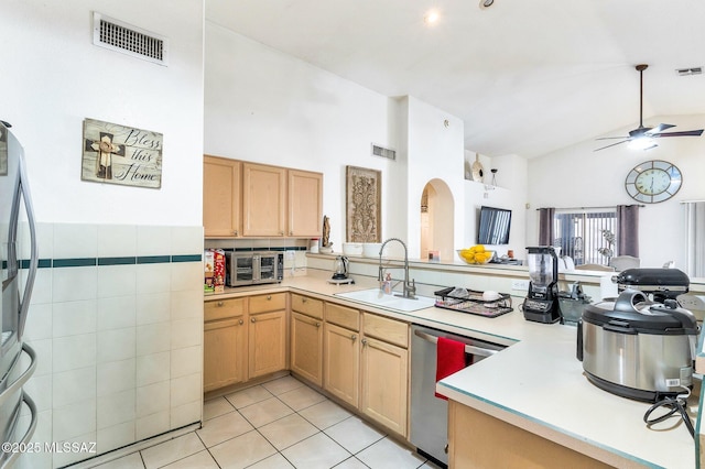 kitchen with stainless steel appliances, light countertops, a sink, and visible vents