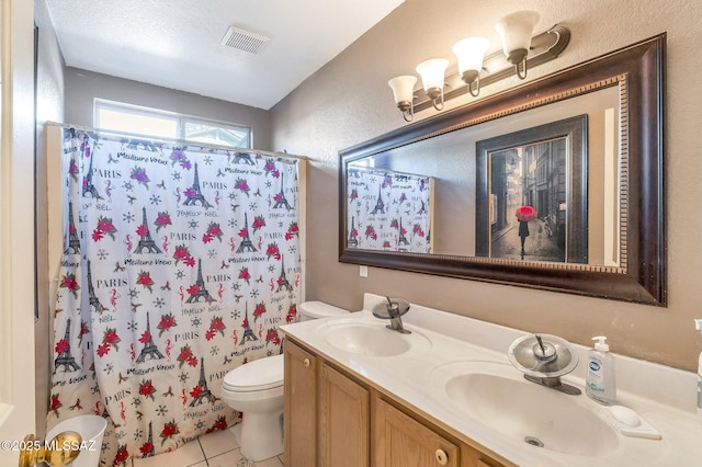 full bathroom with double vanity, tile patterned flooring, a sink, and visible vents