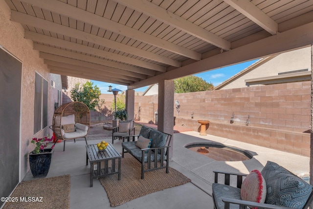 view of patio / terrace featuring an outdoor hangout area, a fenced backyard, and a jacuzzi