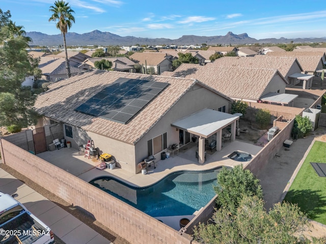 exterior space with stucco siding, a patio area, a mountain view, a residential view, and a fenced backyard