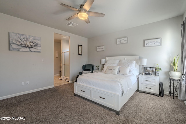 carpeted bedroom with ensuite bathroom and ceiling fan