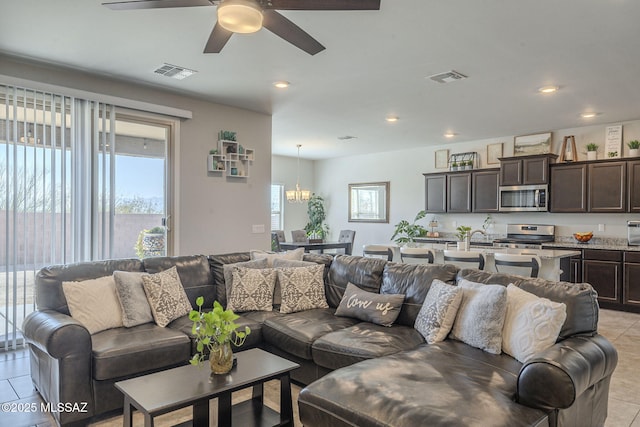 tiled living room with ceiling fan