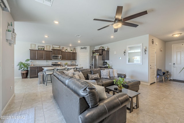 tiled living room with ceiling fan