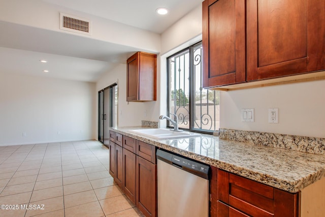 kitchen featuring light tile patterned flooring, dishwasher, light stone counters, and sink