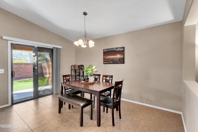 dining room featuring lofted ceiling, light tile patterned floors, baseboards, and an inviting chandelier