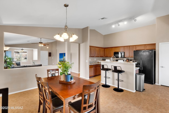 dining room featuring lofted ceiling, visible vents, baseboards, and ceiling fan with notable chandelier