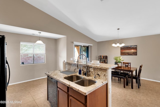 kitchen with dishwasher, vaulted ceiling, a sink, and a wealth of natural light