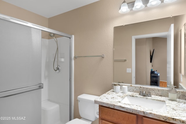 full bath with toilet, a shower stall, and vanity