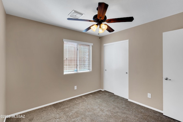 unfurnished bedroom featuring carpet floors, a closet, visible vents, and baseboards