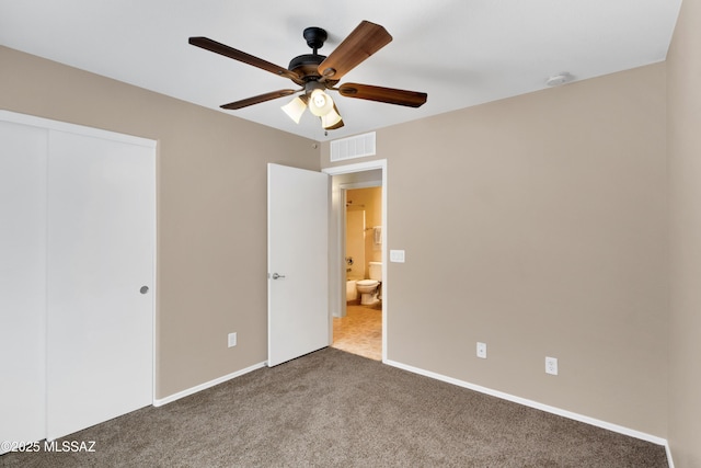 unfurnished bedroom with a closet, visible vents, carpet flooring, ceiling fan, and baseboards