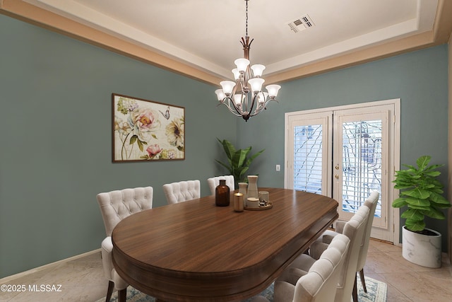 dining room featuring a notable chandelier, light tile patterned floors, a raised ceiling, and french doors