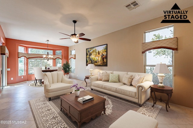 living room with ceiling fan with notable chandelier and light tile patterned flooring