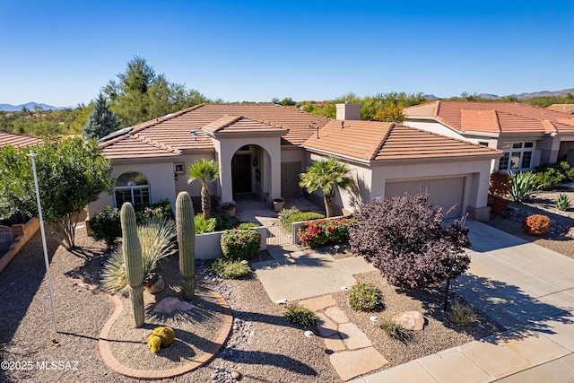 view of front of property featuring a mountain view and a garage