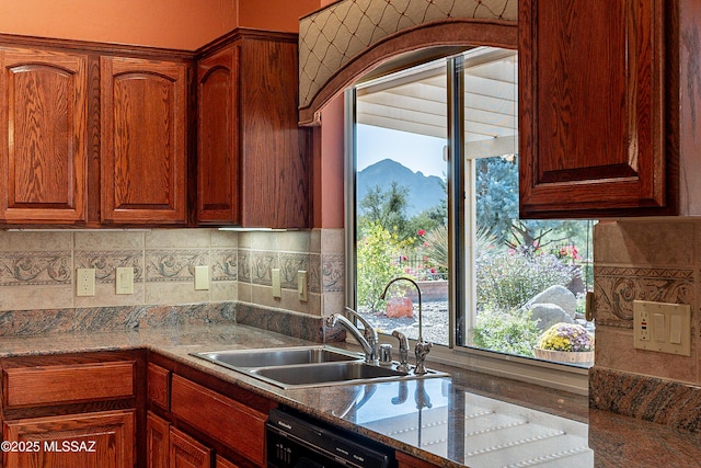 kitchen with sink, tasteful backsplash, a mountain view, dishwasher, and dark stone counters