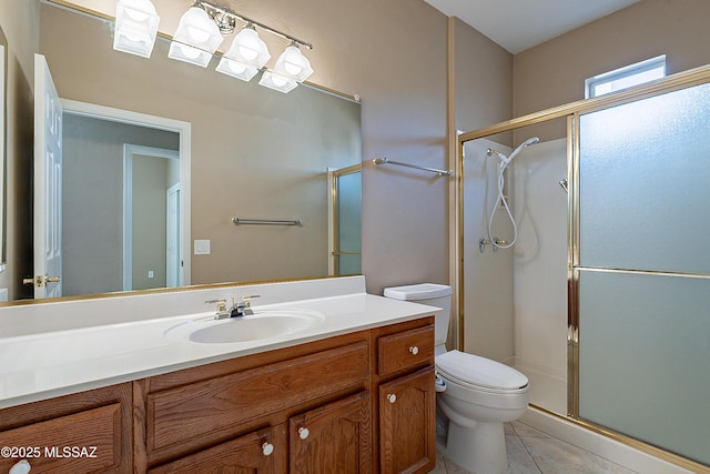 bathroom featuring vanity, an enclosed shower, tile patterned flooring, and toilet