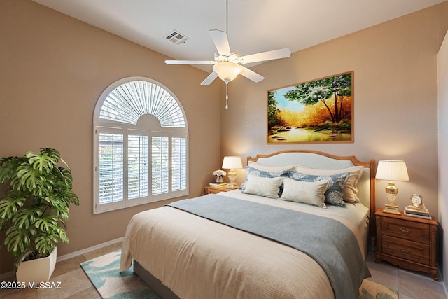 tiled bedroom with ceiling fan