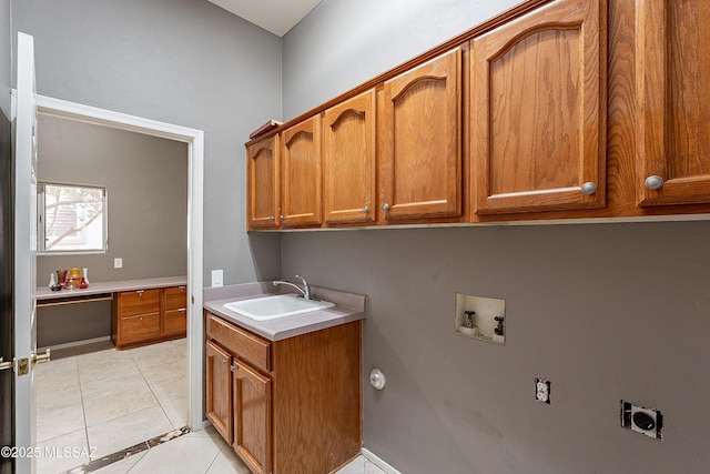 washroom featuring sink, electric dryer hookup, cabinets, washer hookup, and light tile patterned flooring