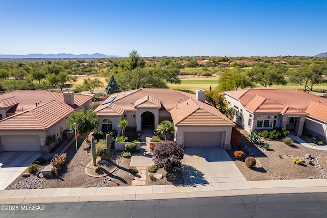 view of front of property featuring a garage and a mountain view