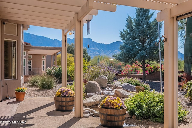 view of patio with a mountain view and a pergola