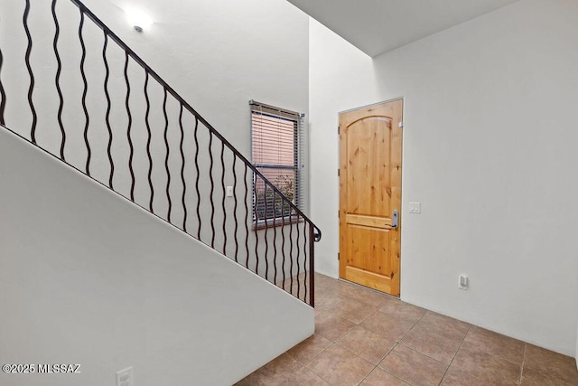 stairway with tile patterned floors