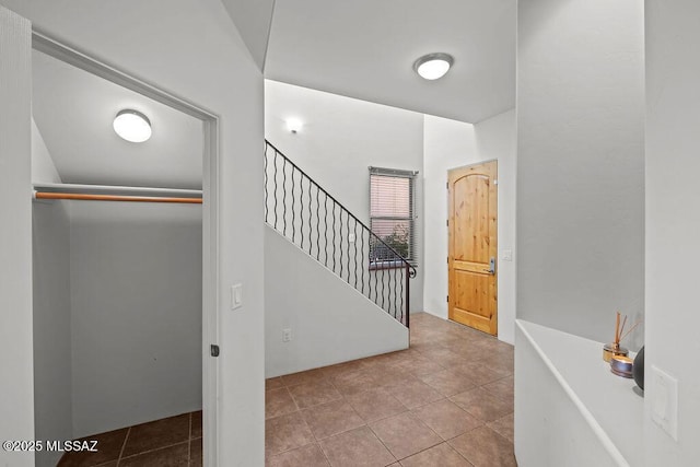 staircase featuring tile patterned flooring